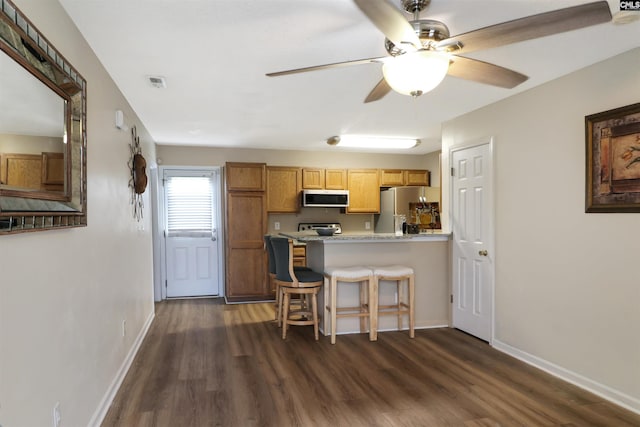 1306 Waverly Place Dr, Columbia, SC 29223 - kitchen with freestanding refrigerator, dark wood finished floors, a peninsula, and a kitchen bar