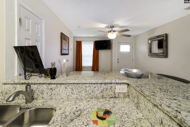 1306 Waverly Place Dr, Columbia, SC 29223 - kitchen featuring a sink, ceiling fan, and light stone counters
