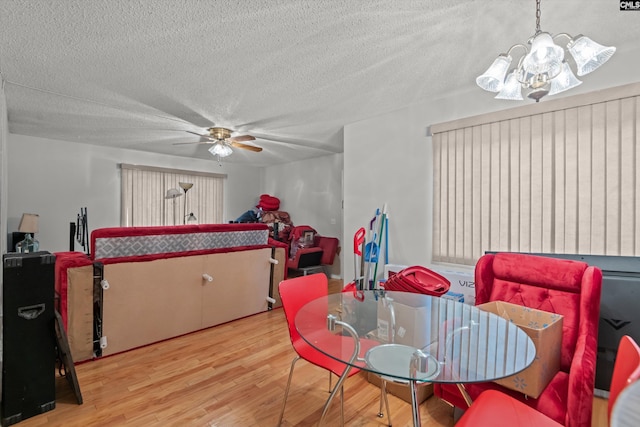 1208 Bush River Rd Unit G10, Columbia, SC 29210 - dining area featuring a ceiling fan, wood finished floors, a textured ceiling, and a chandelier