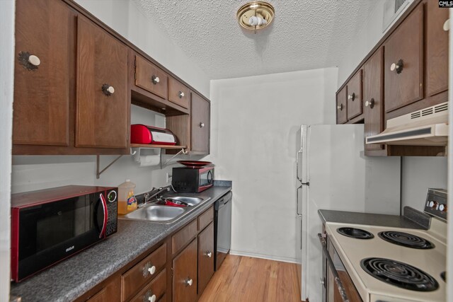 1208 Bush River Rd Unit G10, Columbia, SC 29210 - kitchen featuring black microwave, white electric range oven, under cabinet range hood, a sink, and a textured ceiling
