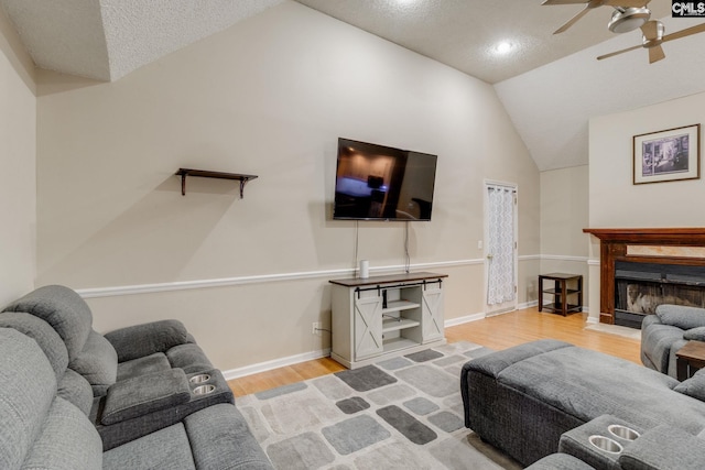 251 Kyzer Rd, Lexington, SC 29073 - living area featuring vaulted ceiling, wood finished floors, a ceiling fan, a textured ceiling, and a fireplace