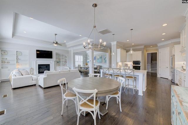 2 Beaver Lake Ct, Elgin, SC 29045 - dining space with ceiling fan, crown molding, dark wood-style floors, a glass covered fireplace, and built in features