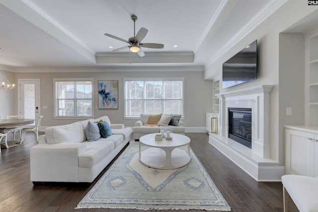 2 Beaver Lake Ct, Elgin, SC 29045 - living area featuring a tray ceiling, ceiling fan, a chandelier, dark wood finished floors, and a fireplace
