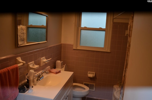 828 Seay Dr, West Columbia, SC 29170 - full bathroom with toilet, vanity, a shower, tile walls, and a wainscoted wall
