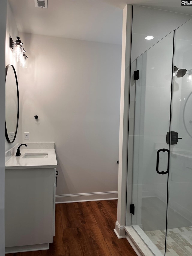 1781 Bookman Rd, Elgin, SC 29045 - full bathroom featuring double vanity, wood finished floors, a stall shower, and baseboards