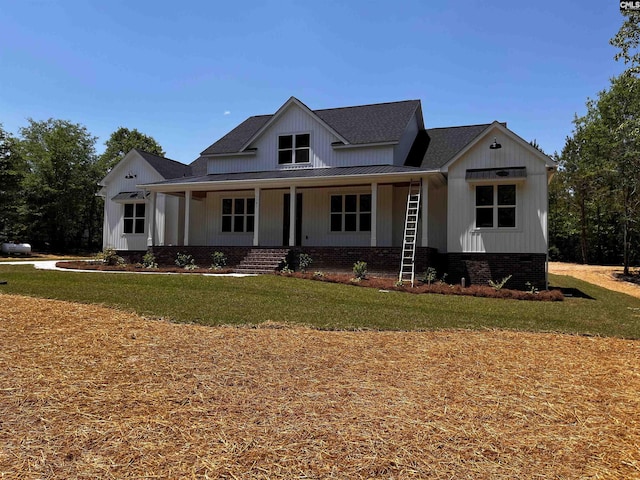 1781 Bookman Rd, Elgin, SC 29045 - modern farmhouse featuring a front yard, a porch, a shingled roof, and metal roof