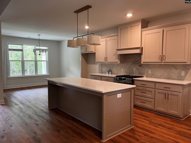 1781 Bookman Rd, Elgin, SC 29045 - kitchen featuring stainless steel range with gas cooktop, a kitchen island, dark wood finished floors, light countertops, and backsplash