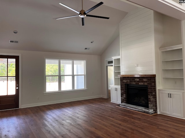 1781 Bookman Rd, Elgin, SC 29045 - unfurnished living room with ceiling fan, baseboards, dark wood-type flooring, high vaulted ceiling, and a fireplace