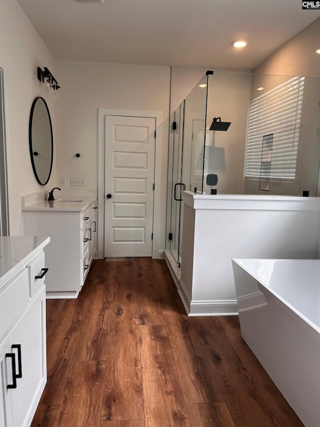 1781 Bookman Rd, Elgin, SC 29045 - full bathroom with vanity, a shower stall, a soaking tub, and wood finished floors