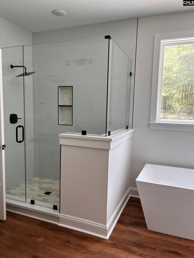 1781 Bookman Rd, Elgin, SC 29045 - full bathroom featuring a stall shower, wood finished floors, a soaking tub, and baseboards