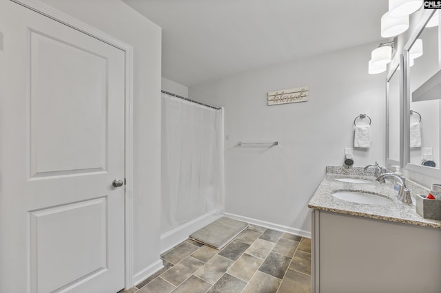 133 Plum Orchard Dr, West Columbia, SC 29170 - full bathroom featuring double vanity, baseboards, a shower with curtain, and stone finish flooring