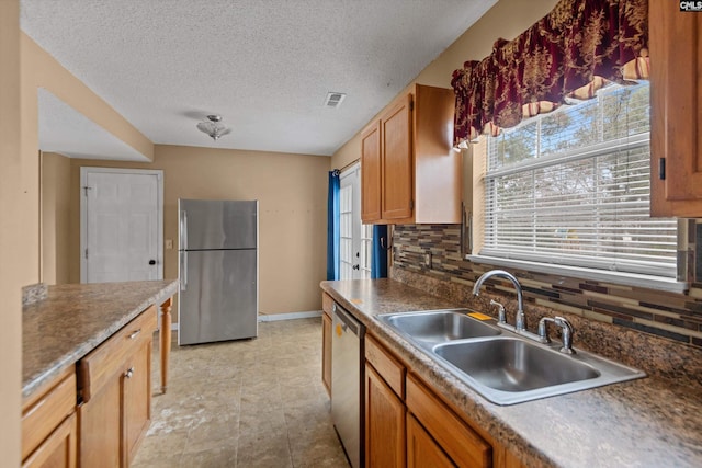 2 Berry Ridge Ct, Columbia, SC 29229 - kitchen with appliances with stainless steel finishes, a sink, tasteful backsplash, baseboards, and a textured ceiling