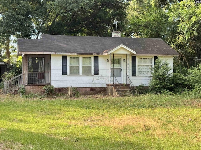 2503 Haile St, Camden, SC 29020 - view of front of house featuring a front lawn, entry steps, roof with shingles, and a chimney