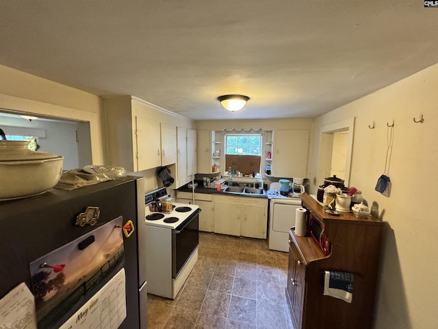 2503 Haile St, Camden, SC 29020 - kitchen with white range with electric cooktop, a sink, washer / dryer, white cabinetry, and dark countertops