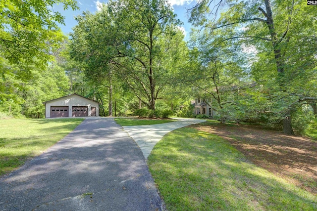 208 Gibbs Rd, Elgin, SC 29045 - view of front of property with a detached garage, a front yard, an outbuilding, and a forest view