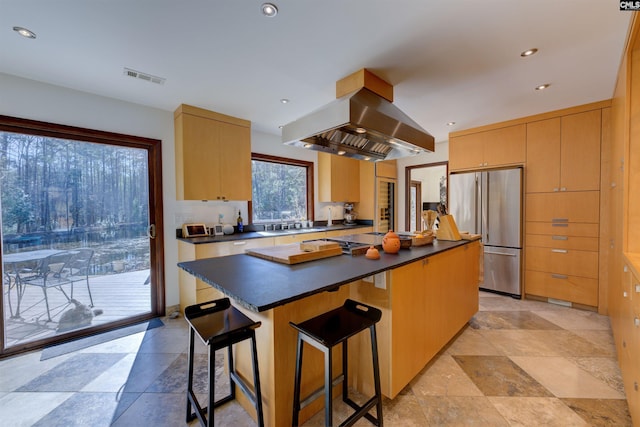 208 Gibbs Rd, Elgin, SC 29045 - kitchen with high end refrigerator, range hood, dark countertops, a kitchen island, and a kitchen bar