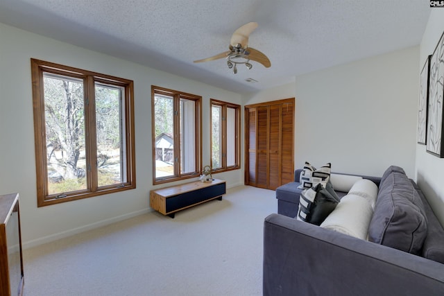 208 Gibbs Rd, Elgin, SC 29045 - living room featuring carpet flooring, ceiling fan, a textured ceiling, and baseboards