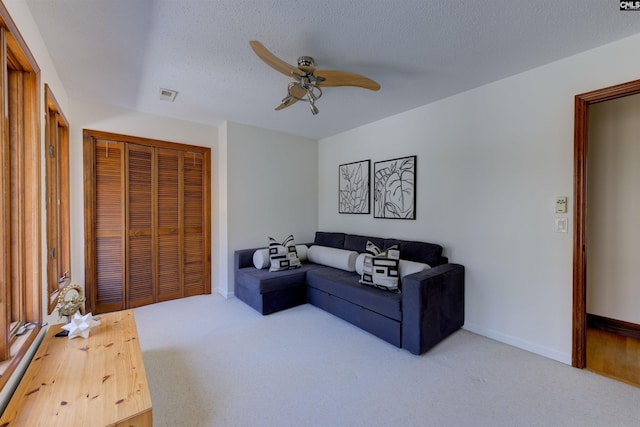 208 Gibbs Rd, Elgin, SC 29045 - carpeted living room with ceiling fan, a textured ceiling, and baseboards
