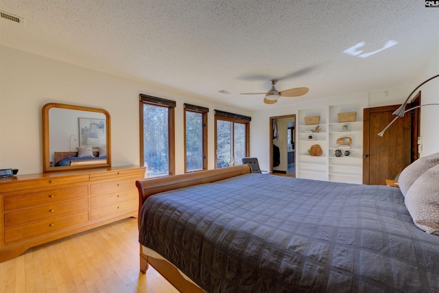 208 Gibbs Rd, Elgin, SC 29045 - bedroom with a textured ceiling, wood finished floors, and a ceiling fan