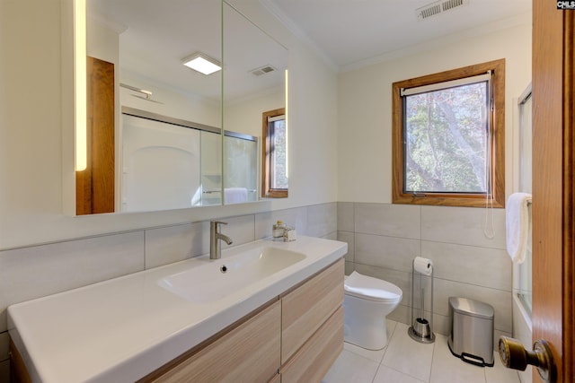 208 Gibbs Rd, Elgin, SC 29045 - full bath featuring toilet, tile walls, vanity, tile patterned floors, and an enclosed shower