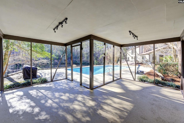 208 Gibbs Rd, Elgin, SC 29045 - unfurnished sunroom featuring rail lighting, floor to ceiling windows, and carpet floors