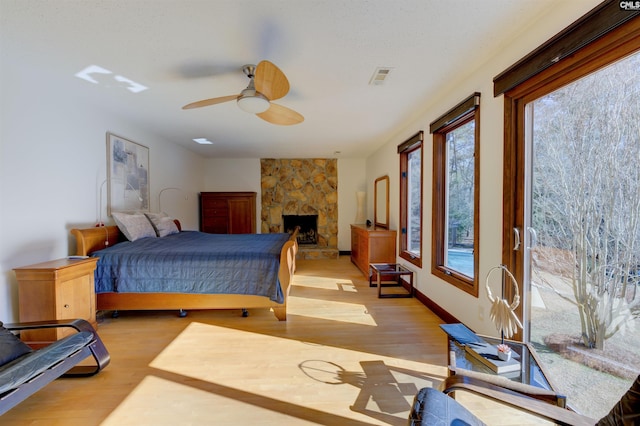 208 Gibbs Rd, Elgin, SC 29045 - bedroom featuring wood finished floors, ceiling fan, and a stone fireplace