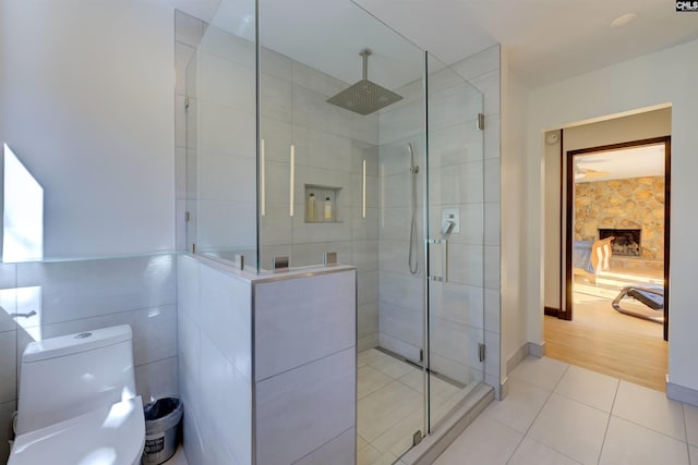 208 Gibbs Rd, Elgin, SC 29045 - bathroom with toilet, a stall shower, tile patterned flooring, and a fireplace