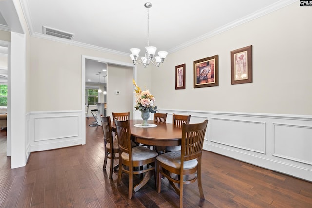 122 Lost Lure Ln, Chapin, SC 29036 - dining space featuring crown molding, dark wood-style flooring, a chandelier, healthy amount of natural light, and a wainscoted wall