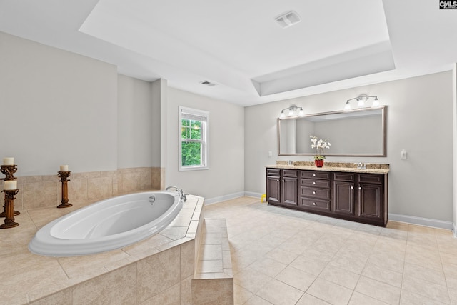 122 Lost Lure Ln, Chapin, SC 29036 - full bath featuring a tray ceiling, double vanity, a garden tub, baseboards, and tile patterned flooring