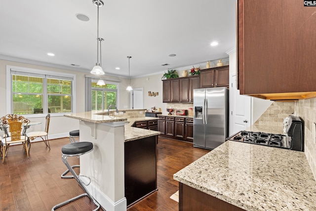 122 Lost Lure Ln, Chapin, SC 29036 - kitchen with stainless steel appliances, ornamental molding, decorative backsplash, a large island, and a kitchen bar