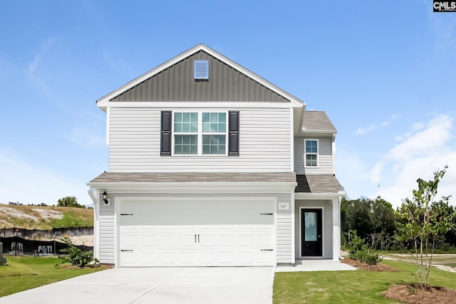 307 Sundew Rd, Elgin, SC 29045 - traditional-style home with a garage, driveway, a shingled roof, a front lawn, and board and batten siding