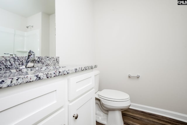 307 Sundew Rd, Elgin, SC 29045 - full bathroom with toilet, vanity, wood finished floors, baseboards, and a shower