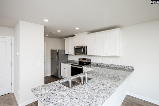 307 Sundew Rd, Elgin, SC 29045 - kitchen featuring appliances with stainless steel finishes, a sink, white cabinetry, baseboards, and dark wood-style floors