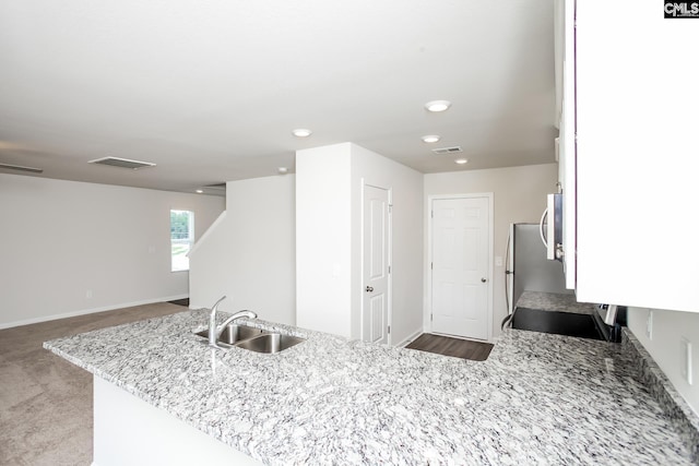 307 Sundew Rd, Elgin, SC 29045 - kitchen featuring a sink, light stone counters, recessed lighting, baseboards, and stove