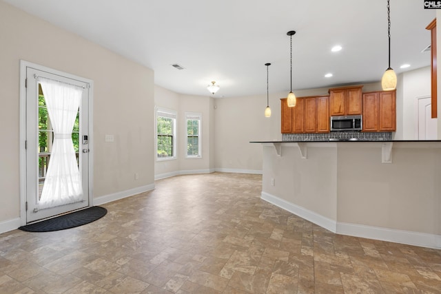 309 Tanners Mill Ct, Chapin, SC 29036 - kitchen with stainless steel microwave, stone tile flooring, baseboards, and recessed lighting