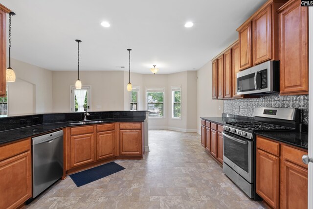 309 Tanners Mill Ct, Chapin, SC 29036 - kitchen with appliances with stainless steel finishes, a sink, decorative backsplash, baseboards, and decorative light fixtures