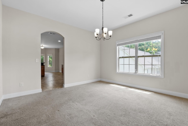 309 Tanners Mill Ct, Chapin, SC 29036 - spare room featuring carpet floors, arched walkways, baseboards, and a chandelier
