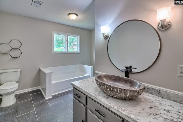 1820 Elm Abode Ter, Columbia, SC 29210 - bathroom with vanity, a garden tub, toilet, tile patterned flooring, and baseboards