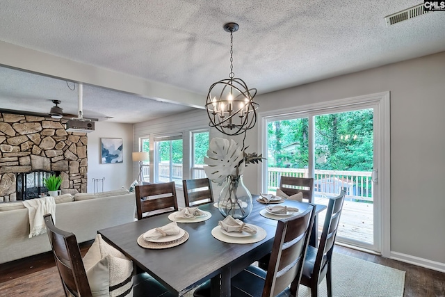 1820 Elm Abode Ter, Columbia, SC 29210 - dining room featuring a textured ceiling, dark wood-type flooring, a chandelier, a fireplace, and baseboards
