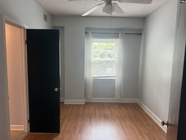 2002 Greene St Unit 113, Columbia, SC 29205 - spare room with a ceiling fan, wood finished floors, a textured ceiling, and baseboards