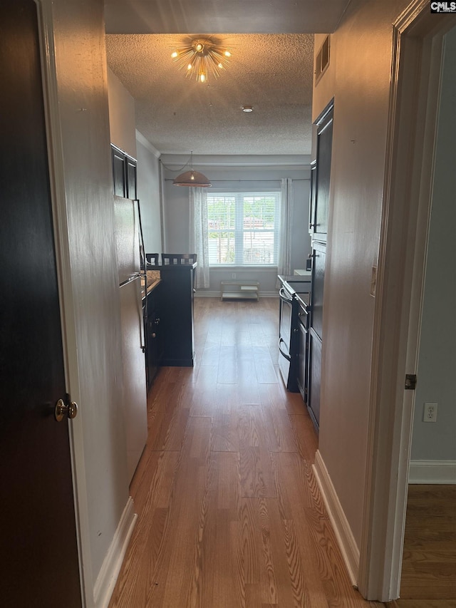 2002 Greene St Unit 113, Columbia, SC 29205 - hall with wood finished floors, a textured ceiling, and baseboards