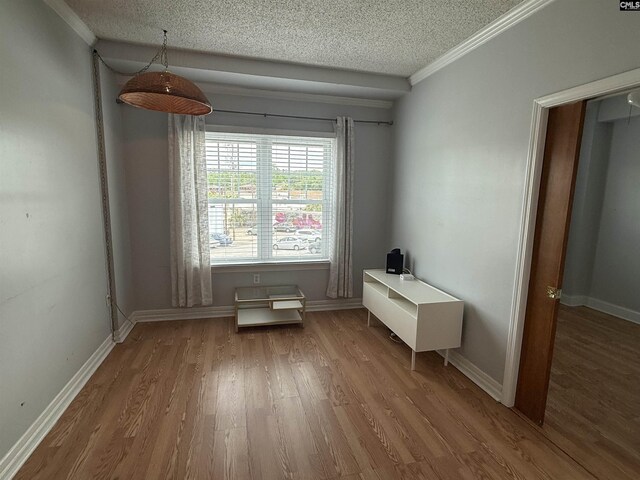 2002 Greene St Unit 113, Columbia, SC 29205 - dining space featuring wood finished floors, a textured ceiling, crown molding, and baseboards