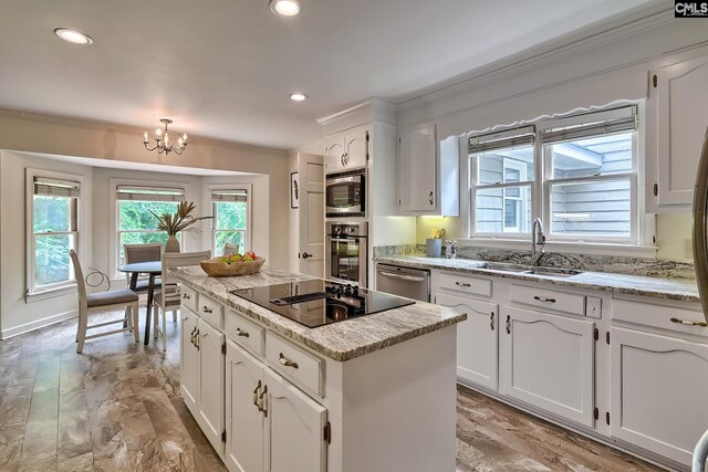 156 Whisperwood Dr, Lexington, SC 29072 - kitchen featuring appliances with stainless steel finishes, a center island, healthy amount of natural light, a sink, and crown molding