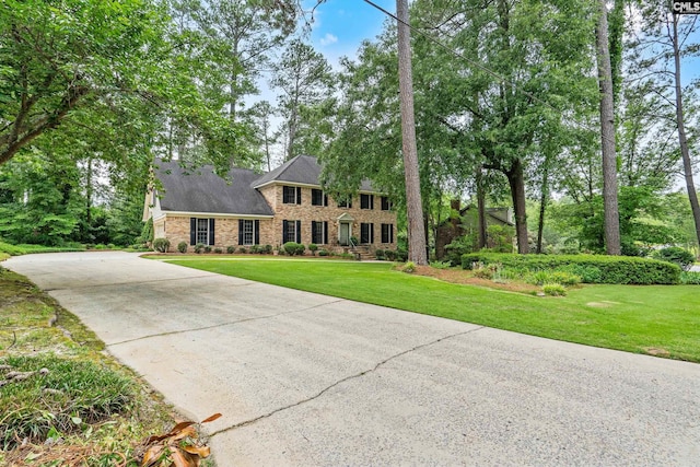 117 Brookspring Rd, Columbia, SC 29223 - colonial home with concrete driveway, a front lawn, and stone siding
