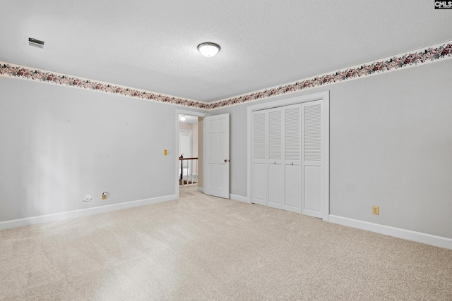 117 Brookspring Rd, Columbia, SC 29223 - unfurnished bedroom featuring light colored carpet, a closet, a textured ceiling, and baseboards