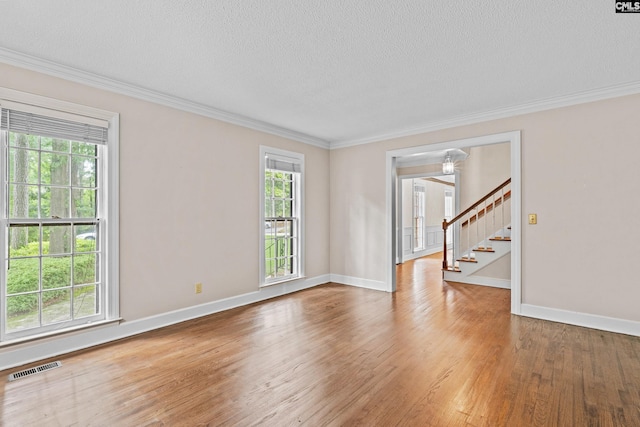 117 Brookspring Rd, Columbia, SC 29223 - spare room featuring healthy amount of natural light, a textured ceiling, ornamental molding, wood finished floors, and stairway
