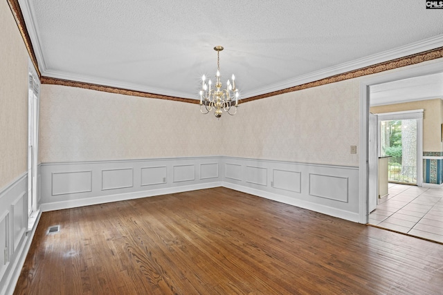 117 Brookspring Rd, Columbia, SC 29223 - empty room with ornamental molding, a chandelier, wainscoting, a textured ceiling, and wood finished floors