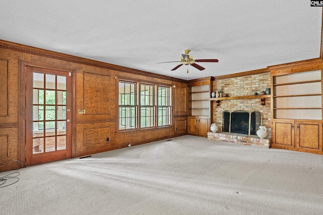 117 Brookspring Rd, Columbia, SC 29223 - unfurnished living room featuring a ceiling fan, a textured ceiling, carpet floors, built in features, and a brick fireplace