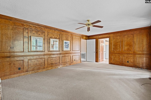 117 Brookspring Rd, Columbia, SC 29223 - carpeted empty room with crown molding, ceiling fan, a decorative wall, a textured ceiling, and wooden walls