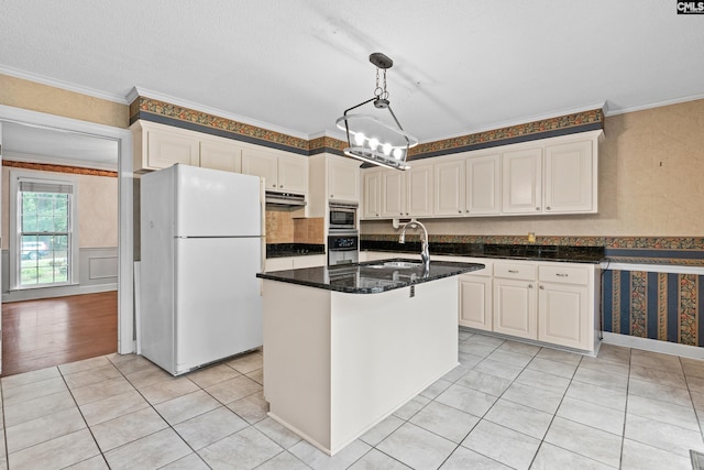 117 Brookspring Rd, Columbia, SC 29223 - kitchen with freestanding refrigerator, stainless steel microwave, oven, a sink, and light tile patterned floors